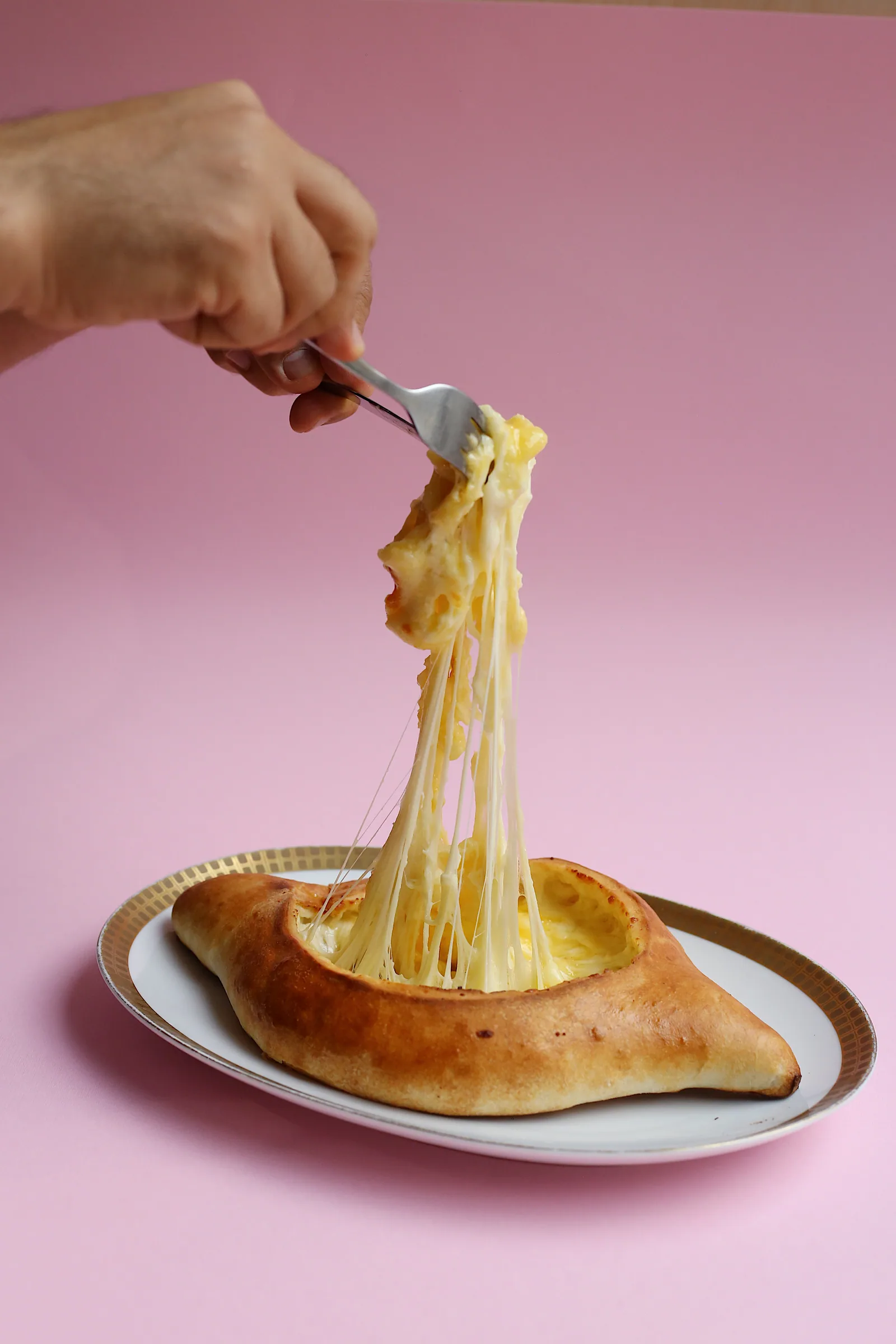 Fresh khachapuri with pulled melted cheese